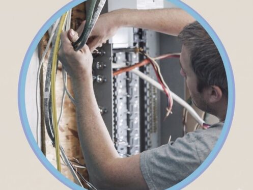 Electrician comparing residential and industrial electrical panel setups