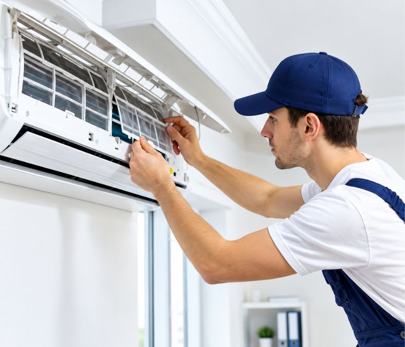 HVAC technician checking airflow and system performance during AC maintenance in Kansas City