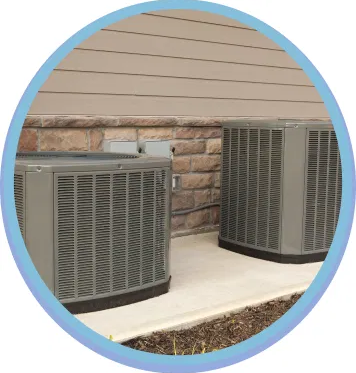 Outdoor heat pump units installed beside a Kansas City home