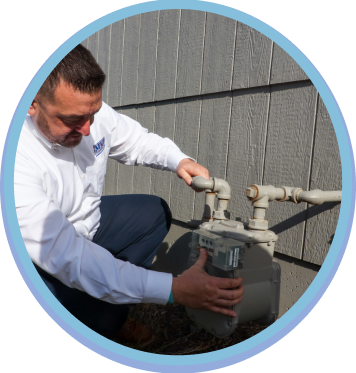 Plumber inspecting residential pipes as part of plumbing services in Lenexa.